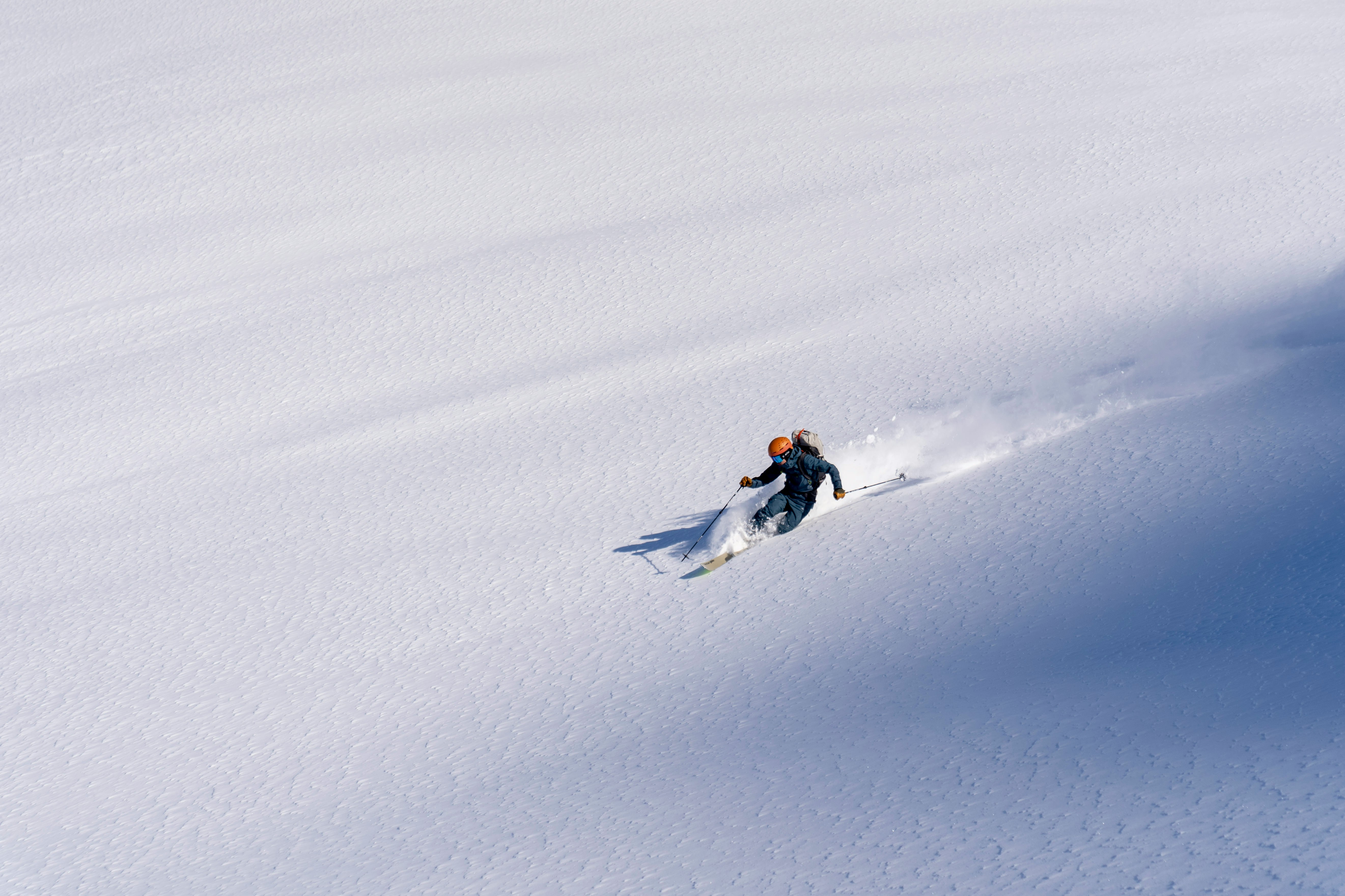 Skier in deep powder on open face — Japan skiing
